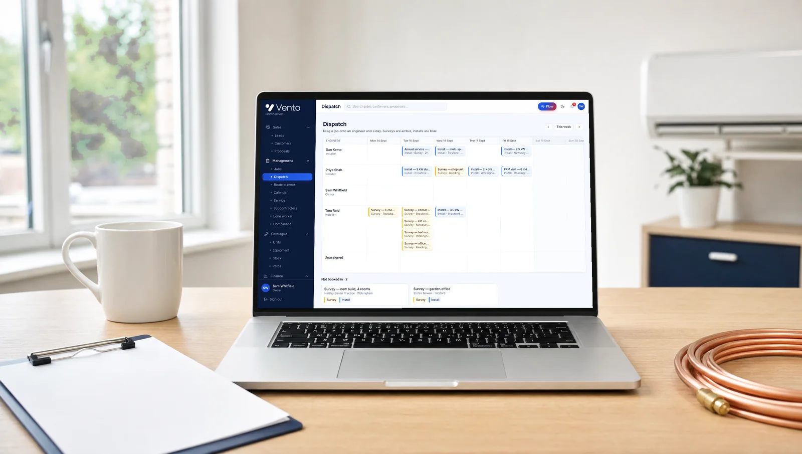 A laptop on an installer's office desk showing Vento's dispatch board for the week.
